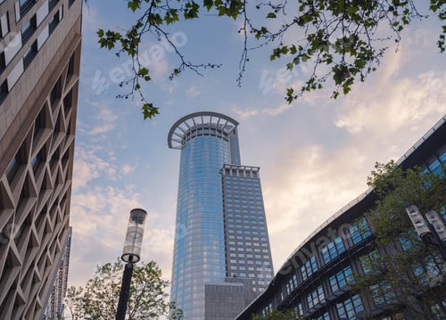 Preview: Bottom view of modern skyscrapers in business district in evening light