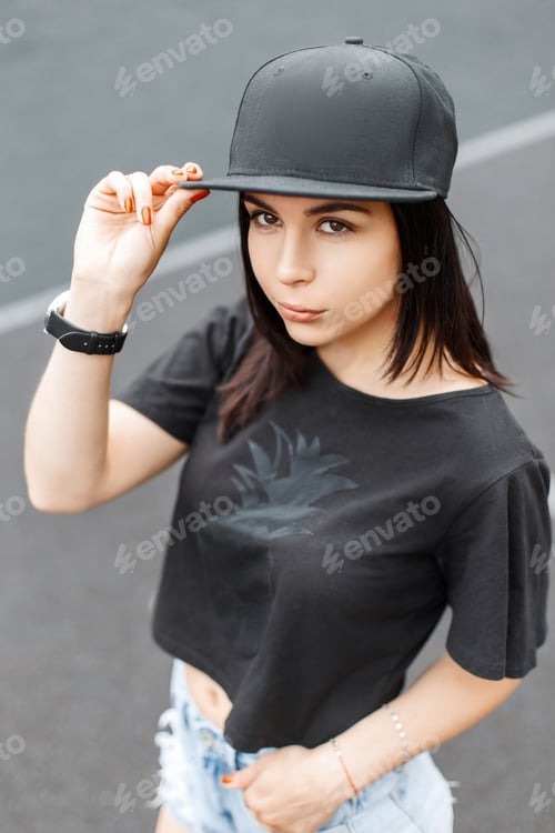 Preview: Stylish young beautiful girl in a black cap and T-shirt.