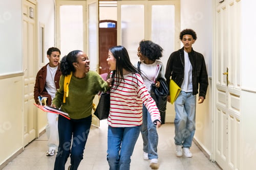 Preview: Diverse students laughing walking along school hallway
