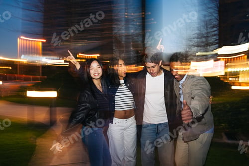 Preview: Diverse friends enjoying night party with motion blur lights