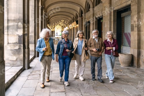 Preview: Group of senior friends walking in city arcade