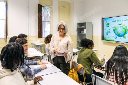 Preview: Teacher distributing exams to students in a classroom