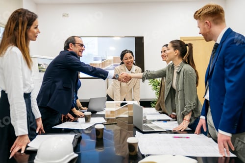 Preview: Business leaders shaking hands concluding real estate deal