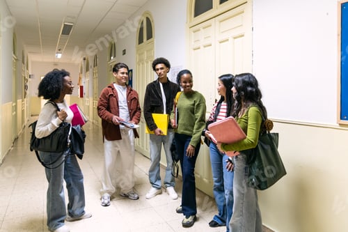 Preview: Diverse high school students laughing talking in hallway