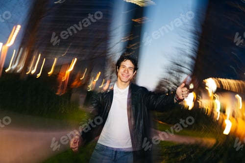 Preview: Young man enjoying nightlife with motion blur lights