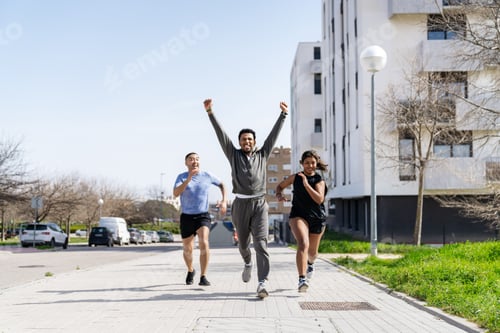 Preview: Diverse friends running together celebrating healthy lifestyle