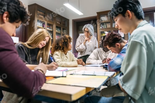 Preview: Teacher shushing diverse students studying in library