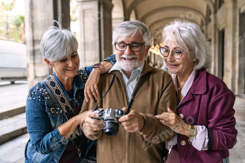 Preview: Senior friends enjoying city vacation reviewing camera
