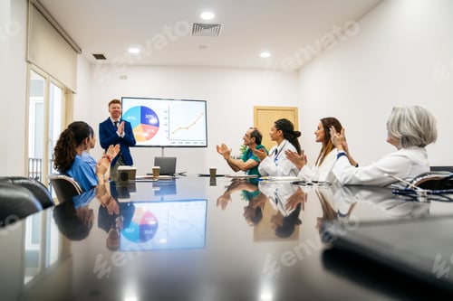 Preview: Healthcare team applauding presenter during medical meeting