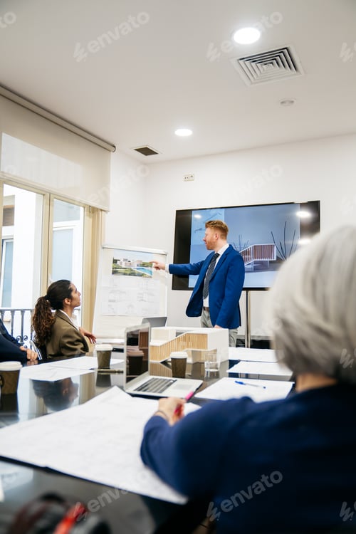 Preview: Real estate developers discussing property blueprints and architectural model