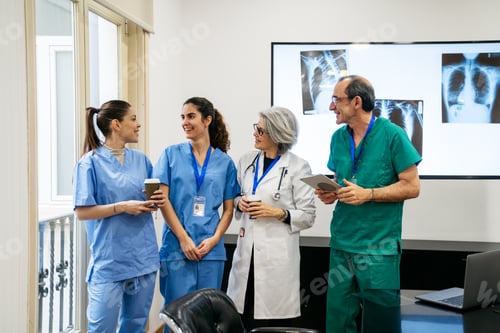 Preview: Medical team collaborating and discussing patient x rays