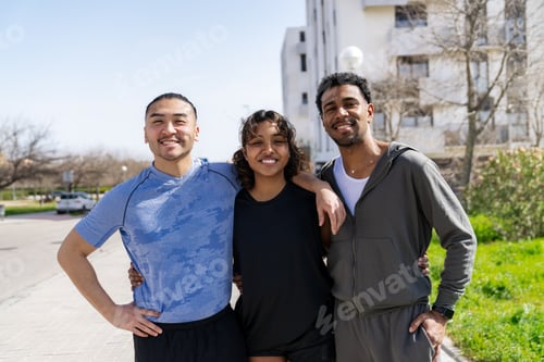 Preview: Diverse friends exercising outdoors smiling after a run