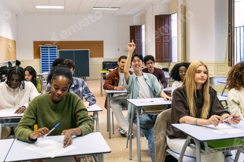 Preview: Diverse students learning in a classroom raising hand