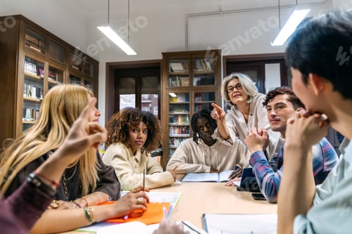 Preview: Diverse students learning with teacher in library