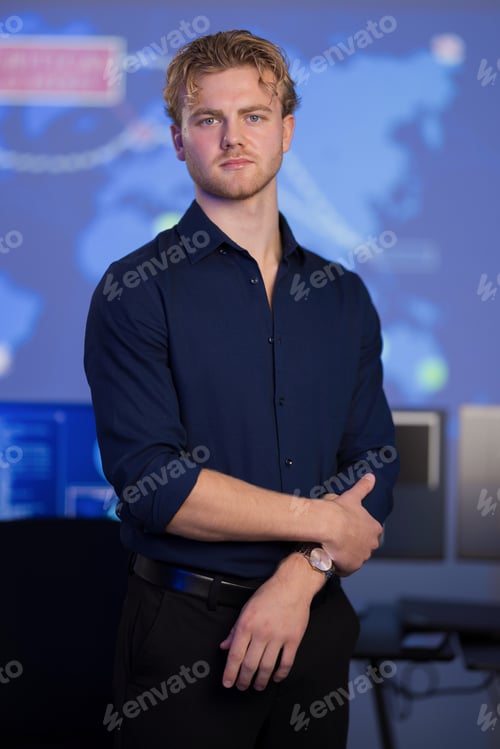 Preview: Confident male analyst in a control room with digital map background