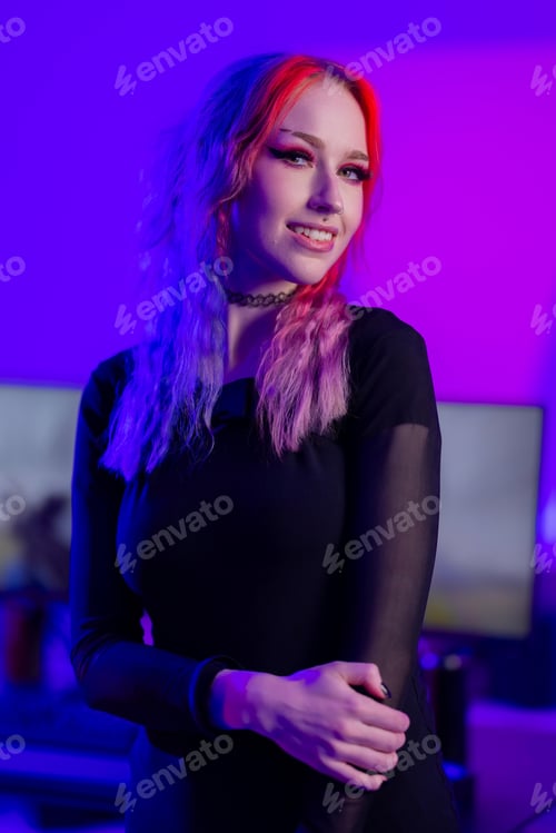 Preview: Young woman with vibrant hair in ambient purple studio lighting