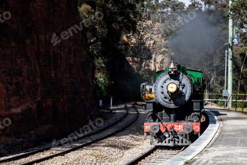 Preview: Vintage Steam Train Traveling Through Rocky Landscape