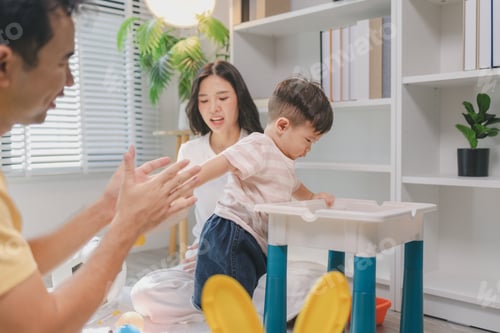 Preview: Mother and father playing with baby using colorful blocks and toys, supporting standing and movement
