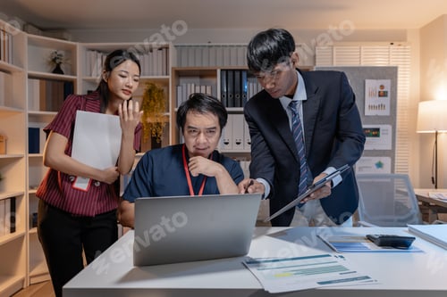 Preview: Business team discussing work together in office, analyzing reports and data on laptop and documents