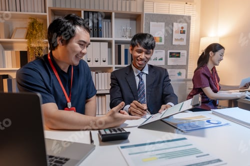 Preview: Business team discussing work together in office, analyzing reports and data on laptop and documents
