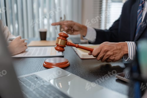 Preview: Professional legal consultation meeting between lawyer and client in office, discussing case documen
