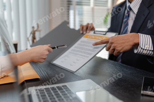 Preview: Professional legal consultation meeting between lawyer and client in office, discussing case documen