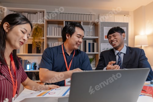 Preview: Business team discussing ideas and reviewing data together in office, using laptop and documents, sh