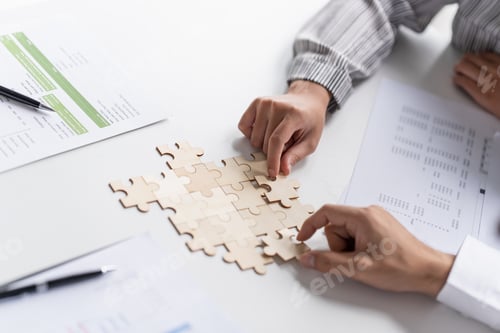 Preview: Businessman hands putting together puzzle pieces with Team Building join together and Business Colla