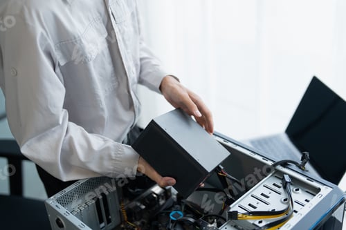 Technician Installing a Power Supply Unit in a Desktop Computer