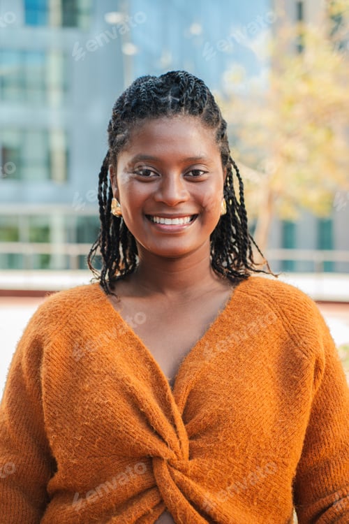 Preview: Cheerful young woman smiling confidently while enjoying a moment of joy and connection with friends