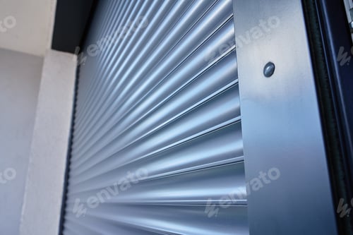 Preview: Modern window with roller shutter closing on house exterior