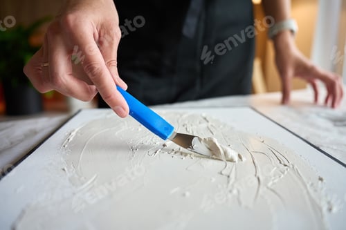 Preview: Artist Applying Texture Paste to Canvas for DIY Wall Decor
