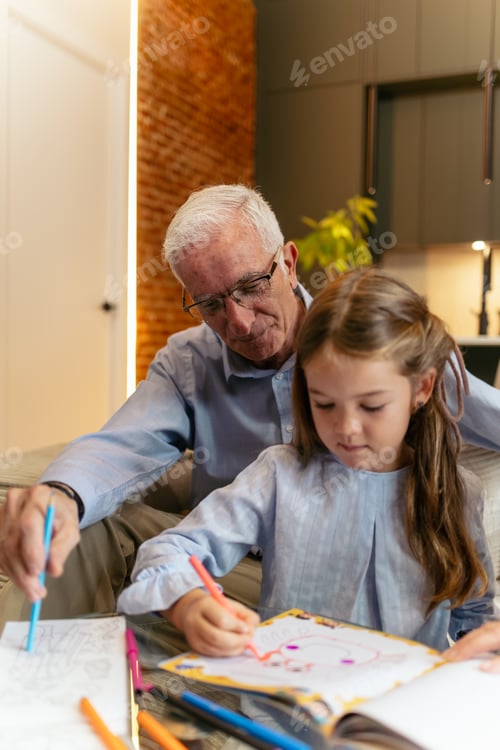 Preview: Grandfather and granddaughter coloring together, enjoying family time