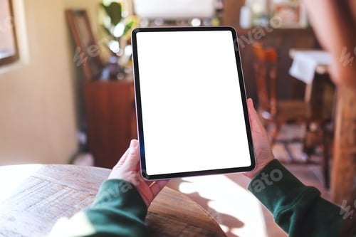 Preview: Mockup image of a woman holding digital tablet with blank white desktop screen in cafe