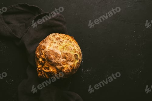 Preview: Organic raw celery root on dark surface with textile cloth. Rustic culinary composition with negativ