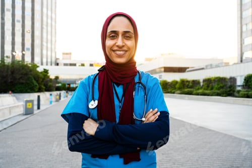 Preview: Muslim female medical worker wearing hijab outside hospital