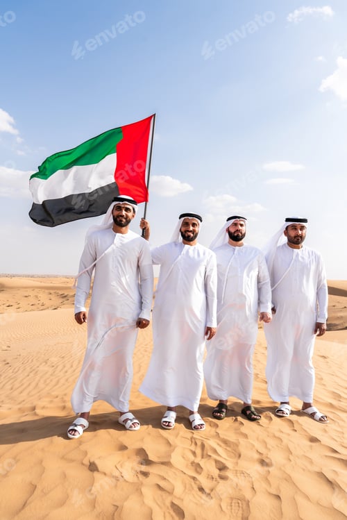 Preview: Group of middle-eastern men wearing traditional emiratis clothing and bonding in Dubai desert