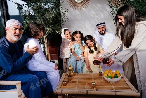 Preview: Arab family sharing dates at outdoor gathering