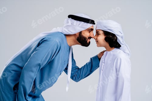 Preview: Arab father showing affection to his son wearing traditional attire