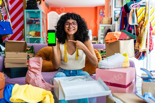 Preview: Beautiful young hispanic woman managing her home e-commerce business from home