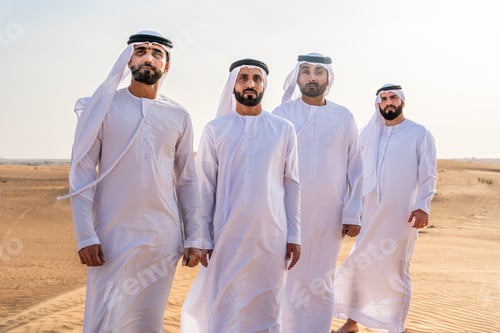 Preview: Four emirati men posing in dubai desert