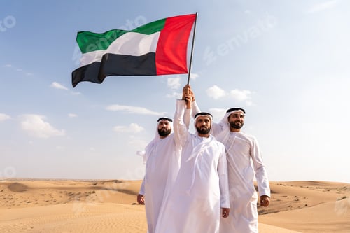 Preview: United arab emirates men raising flag in desert