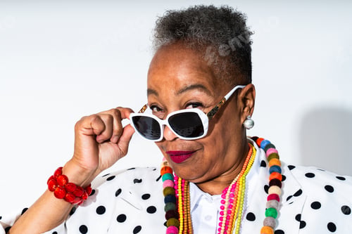 Preview: Senior black woman wearing sunglasses and colorful jewelry