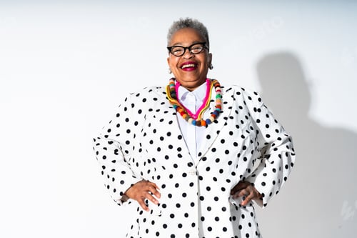 Preview: Confident senior black woman smiling in polka dot blazer