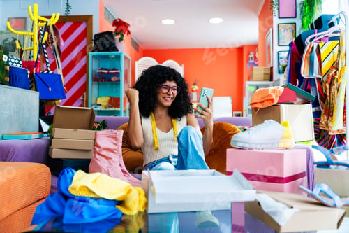 Preview: Beautiful young hispanic woman managing her home e-commerce business from home