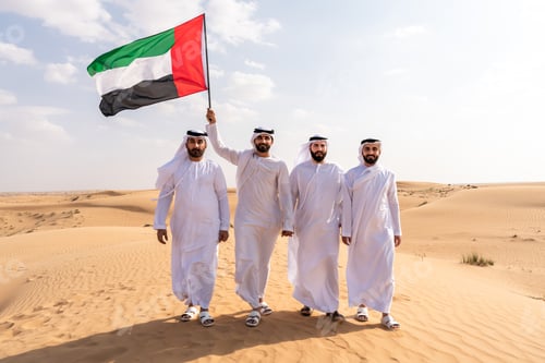 Preview: Arab men holding national flag walking in desert