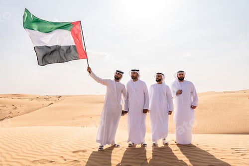Preview: Emirati men holding uae flag in desert celebrating patriotism