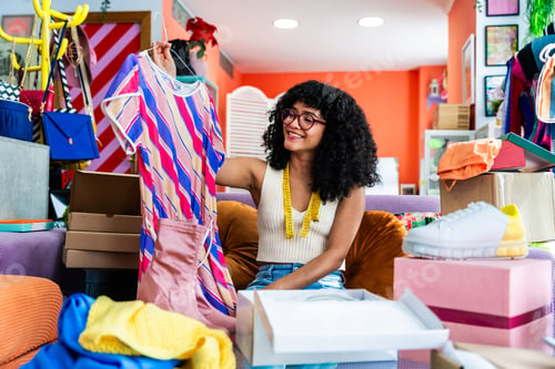 Preview: Beautiful young hispanic woman managing her home e-commerce business from home