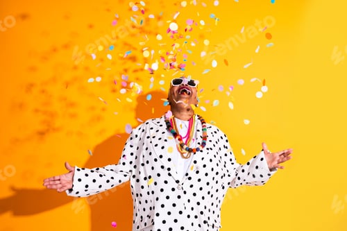 Preview: Senior woman celebrating carnival with colorful confetti