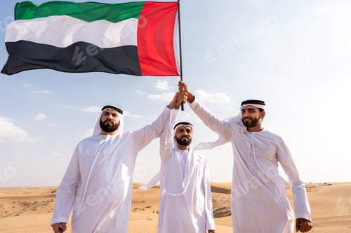 Preview: Emirati men holding united arab emirates flag showing patriotism
